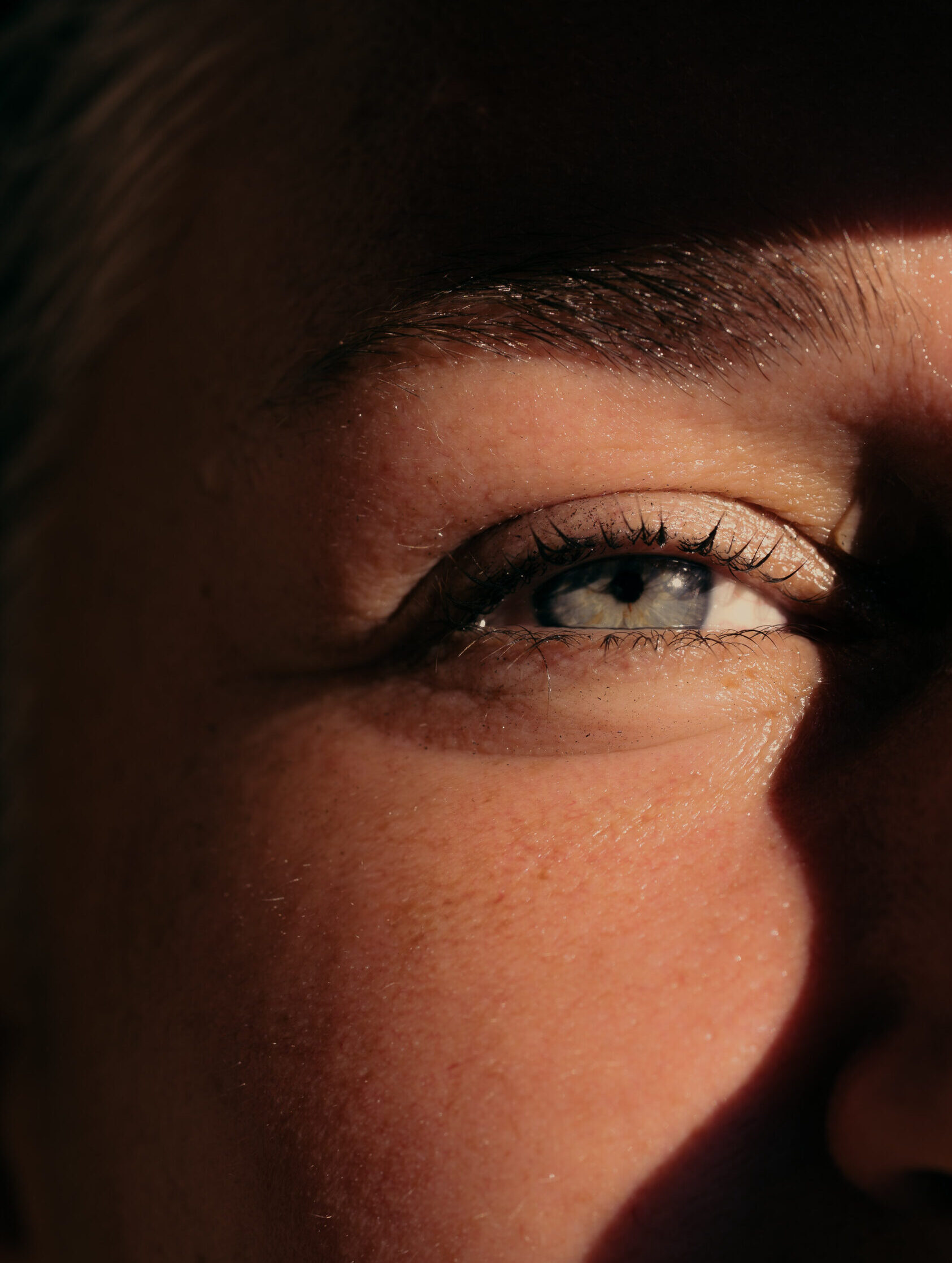 Close-up macro photograph of human eye showing foveal detail and selective focus demonstrating micro to macro scale in vision